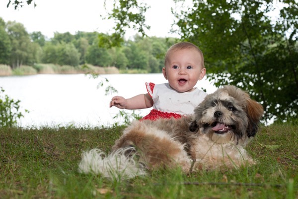 Baby and dog smiling